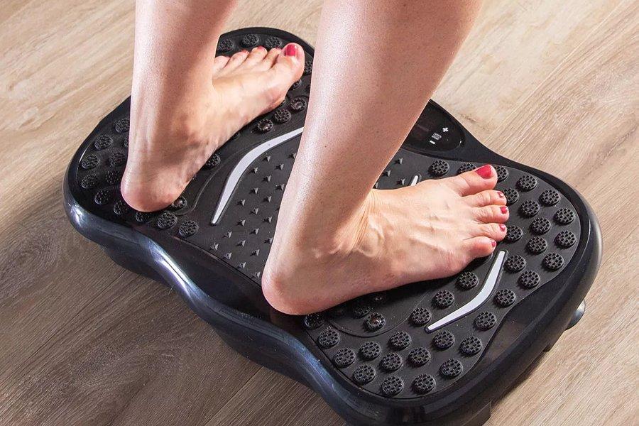 A pair of feet on a vibration plate