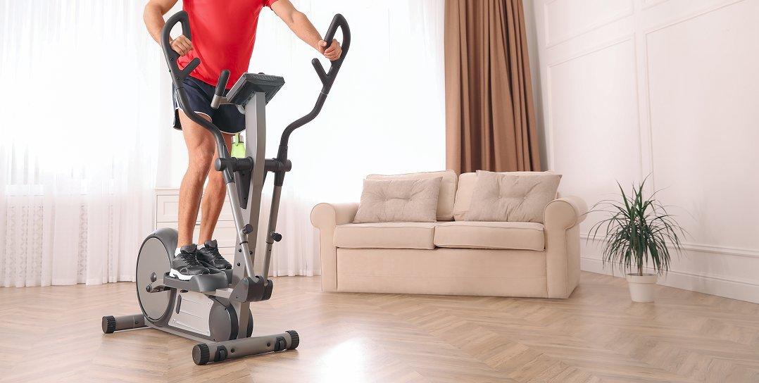 a man is on a stationary exercise bike in a living room