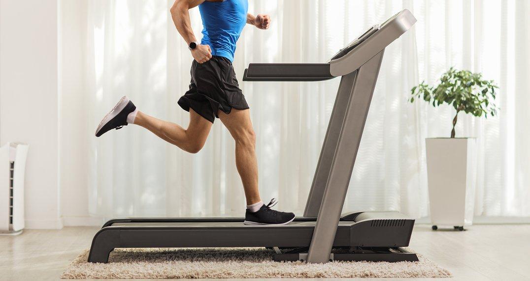 a man running on a treadmill in a living room