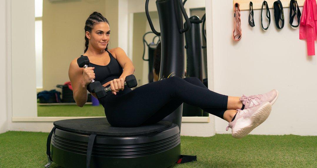 a woman is doing a workout on a fitness machine