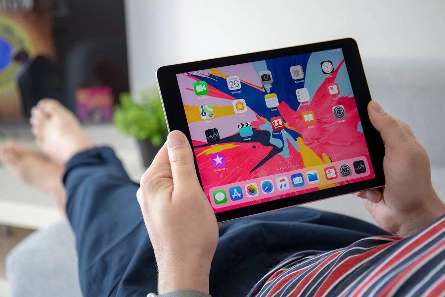 A person lying down using a tablet