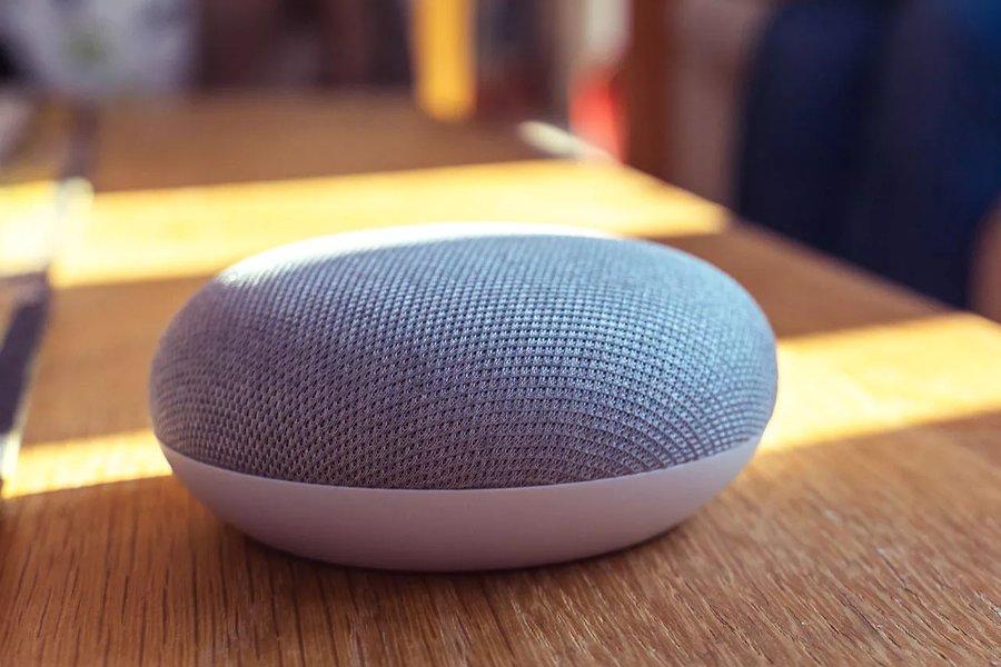a smart speaker on a wooden surface