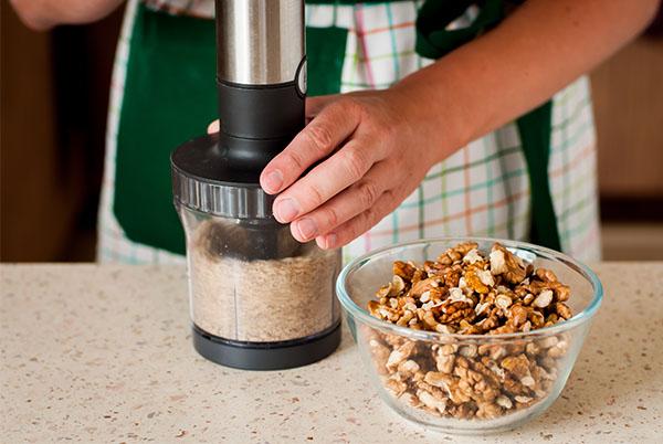 a person is grinding nuts in a food processor in a bowl