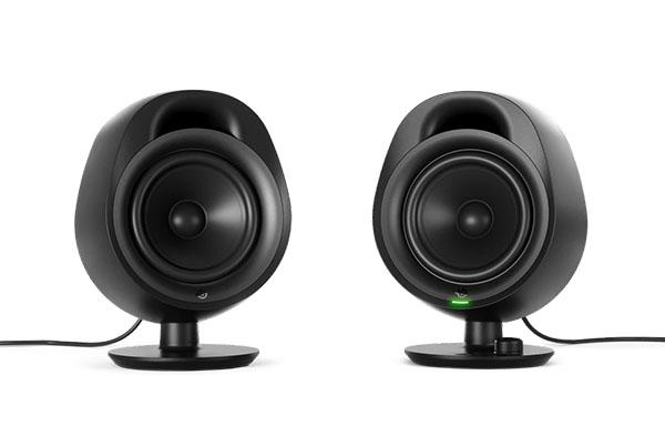 two black speakers are sitting on top of each other