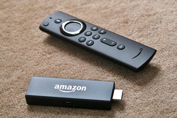 a remote control and a usb device on a carpeted floor