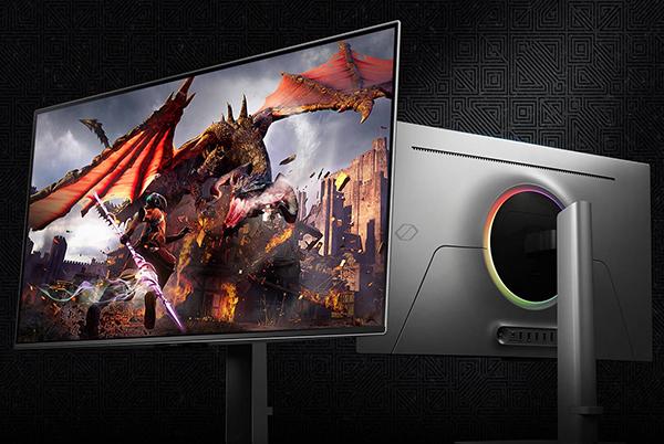 a monitor with a dragon on it next to a computer