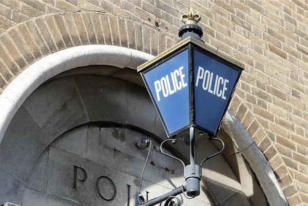 a blue light on a police light on a brick building