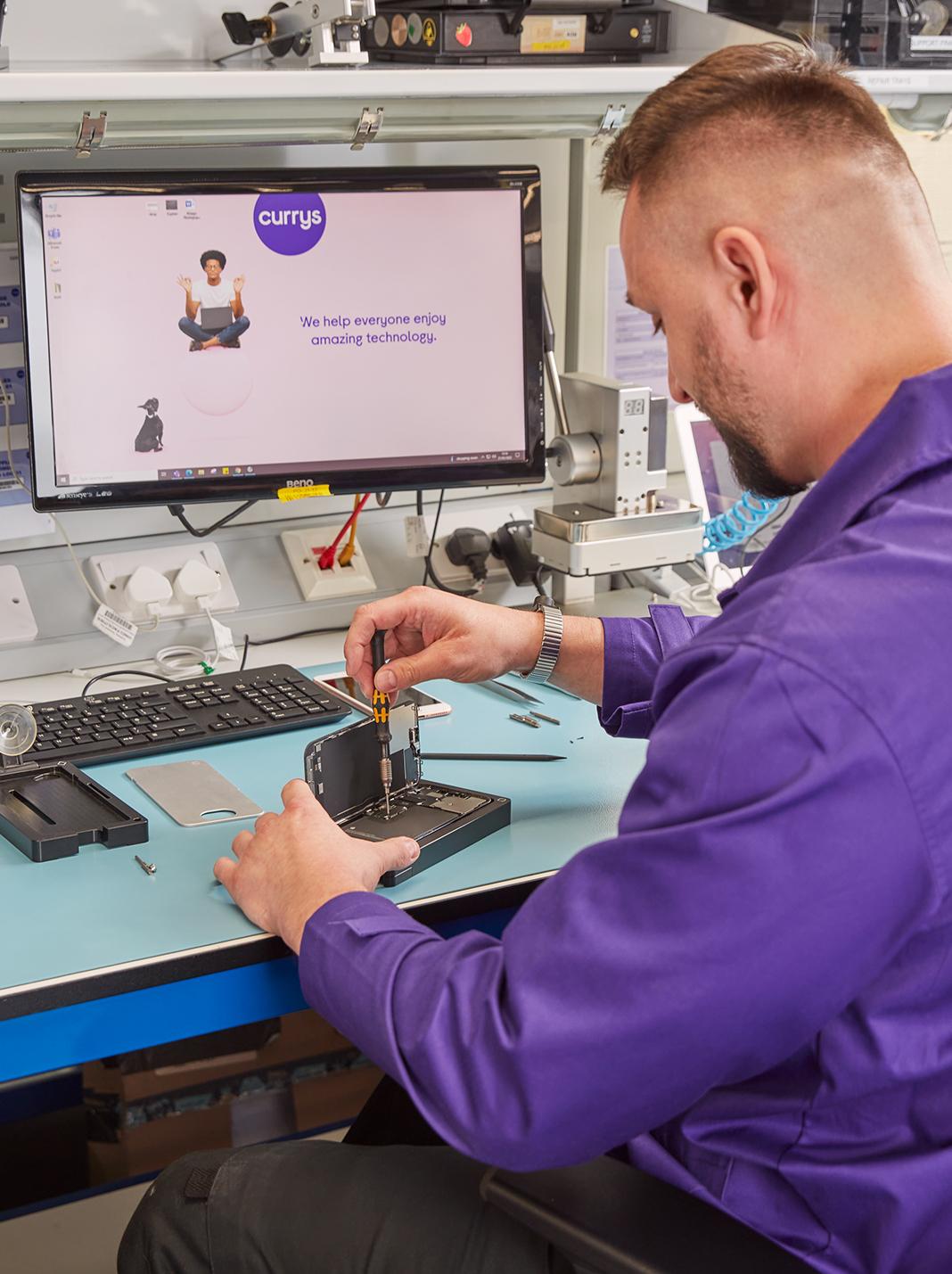 Colleague stripping parts from small gadget