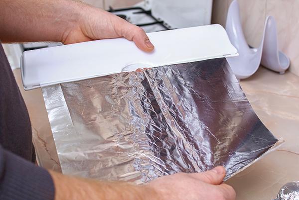 a person holding a piece of foil in their hand