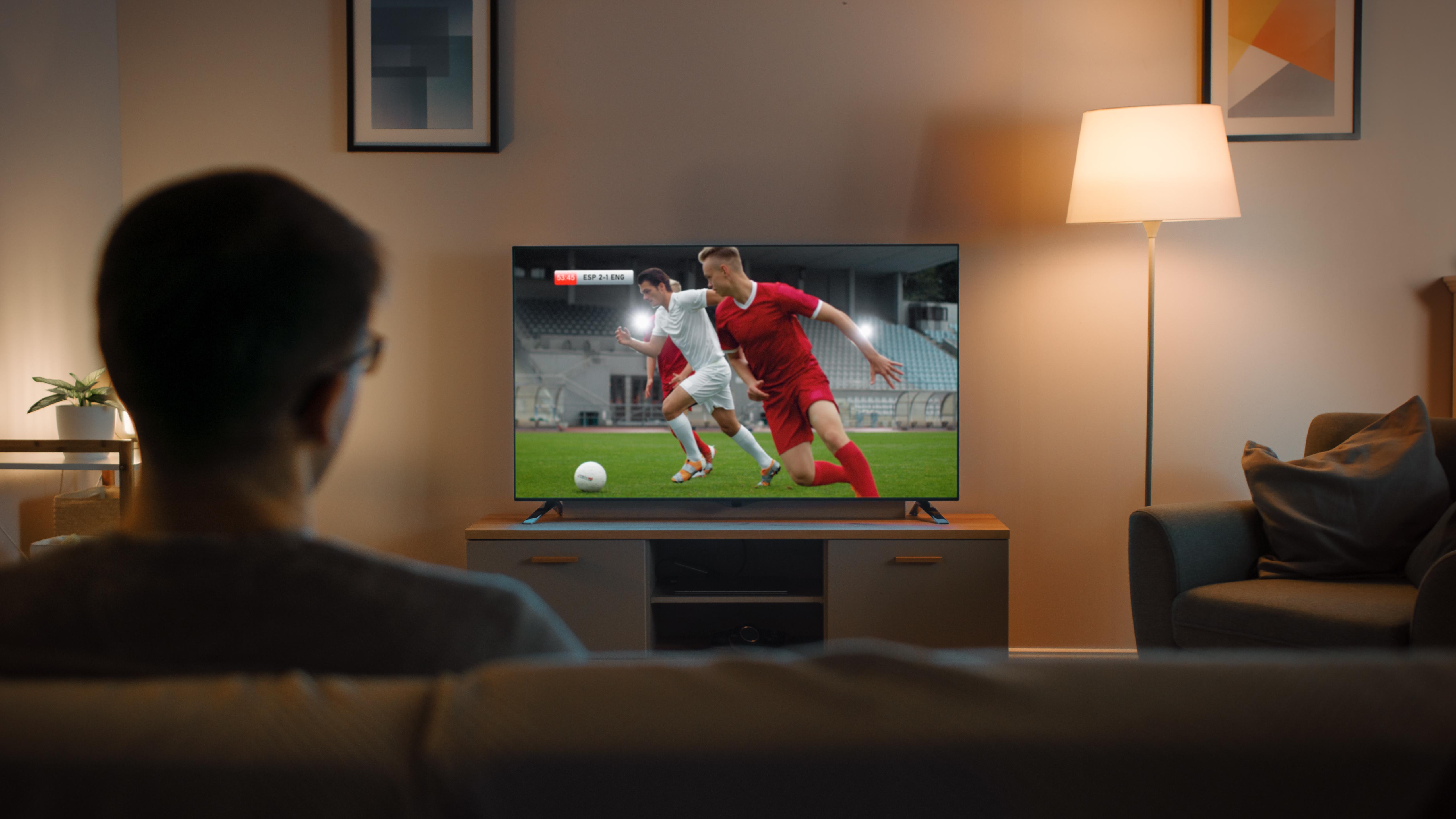 Домашний телевизор с футболом в окне. Sport do you watch on tv