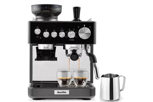 a black coffee machine with two cups and a milk frother