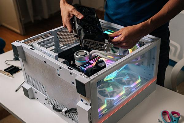 a man is working on a computer in a small case