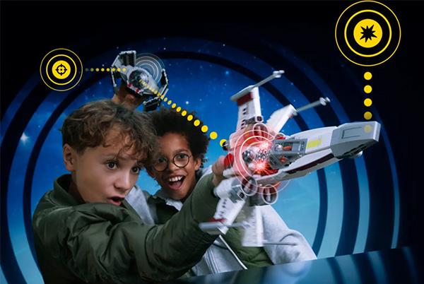 two children playing with a star wars toy in a circular pattern