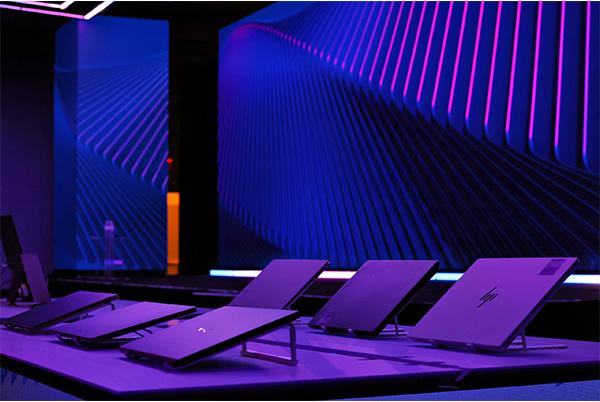 a purple room with a bunch of laptops on a table