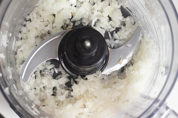a food processor with a bunch of food in it