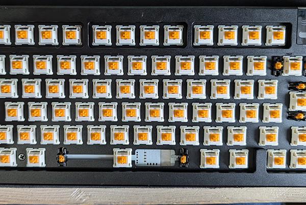 a close up of a computer keyboard with a lot of yellow buttons