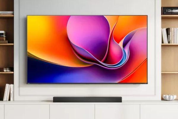 a Hisense A6Q 50" 4K TV is displayed on a wall in a living room