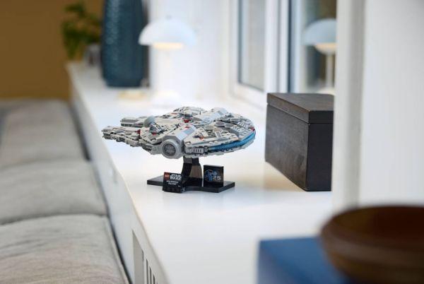 a lego millennium falcon on a shelf next to a box