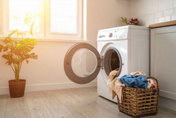 a laundry room with a washing machine and a basket of clothes
