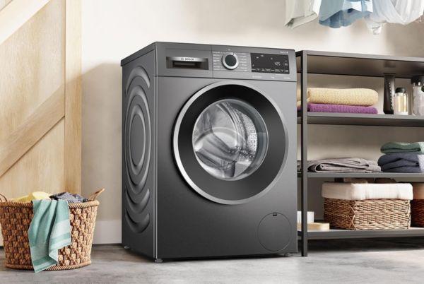 a Bosch Series 6 washing machine in a room with a basket