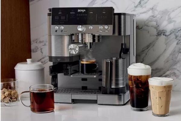 a coffee machine with cups and glasses on a counter