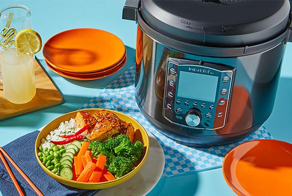 a bowl of food sitting next to a pressure cooker
