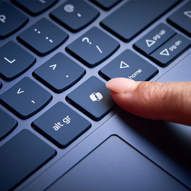 a finger pressing Copilot button on a laptop keyboard