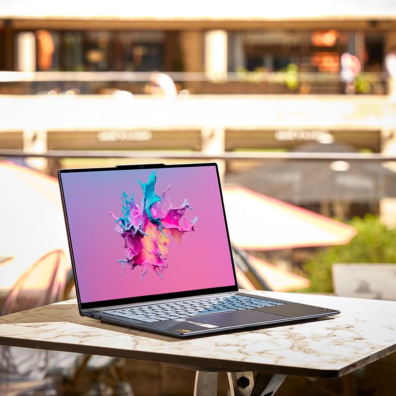 a laptop computer sitting on a table outside on a balcony