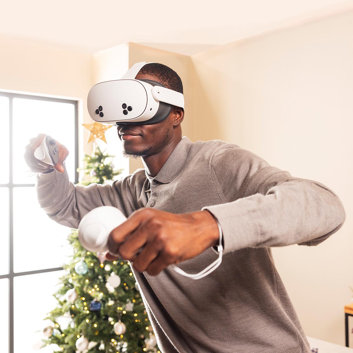 a man playing a Meta Quest 3S with a virtual reality headset