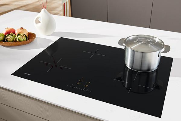 a kitchen counter with a pot and a bowl on it