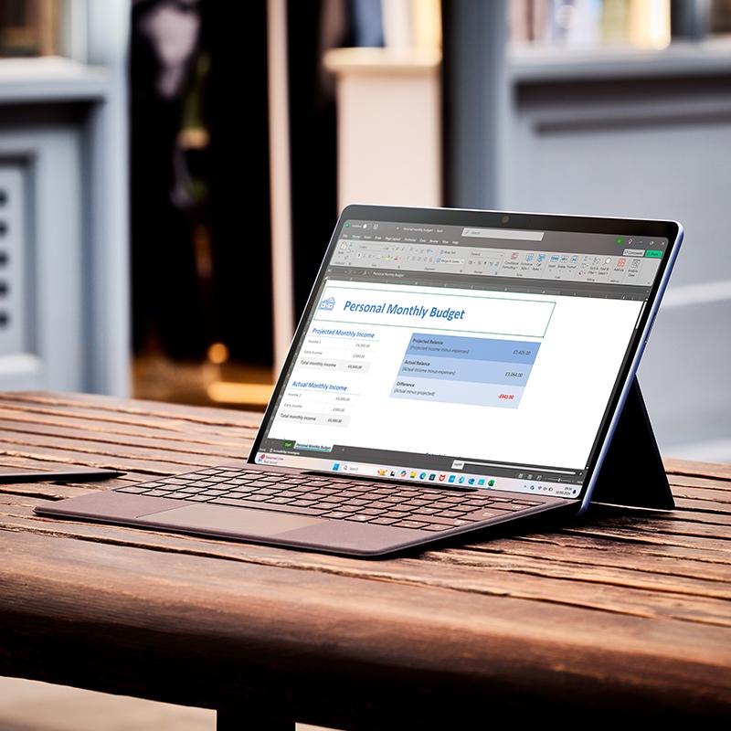 a laptop computer sitting on top of a wooden table