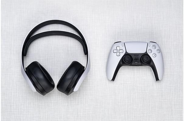 a white controller and headphones on a white surface