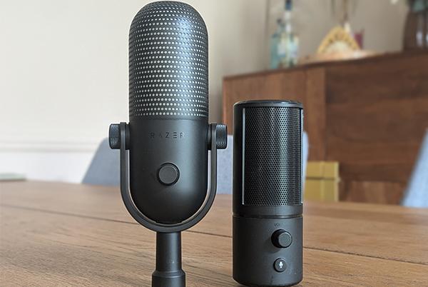 a black microphone and a black speaker sitting on a wooden table