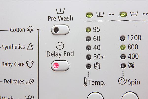 a close up of a washing machine with various buttons and dials