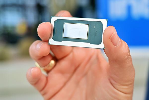 a person holding a small computer chip in their hand