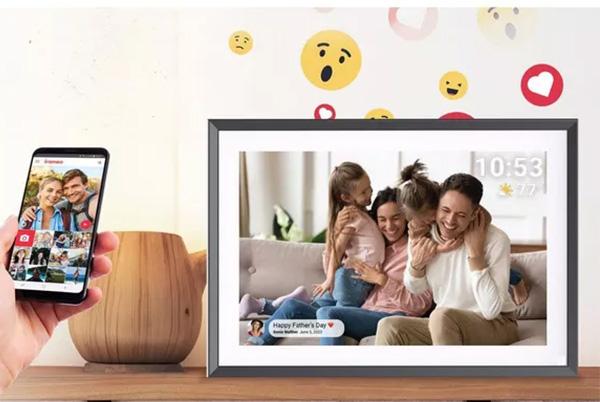 a person holding a phone with a picture of a family on it