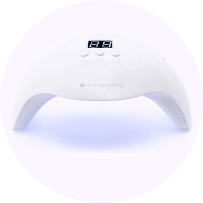 a white lighted nail polish lamp with a white button