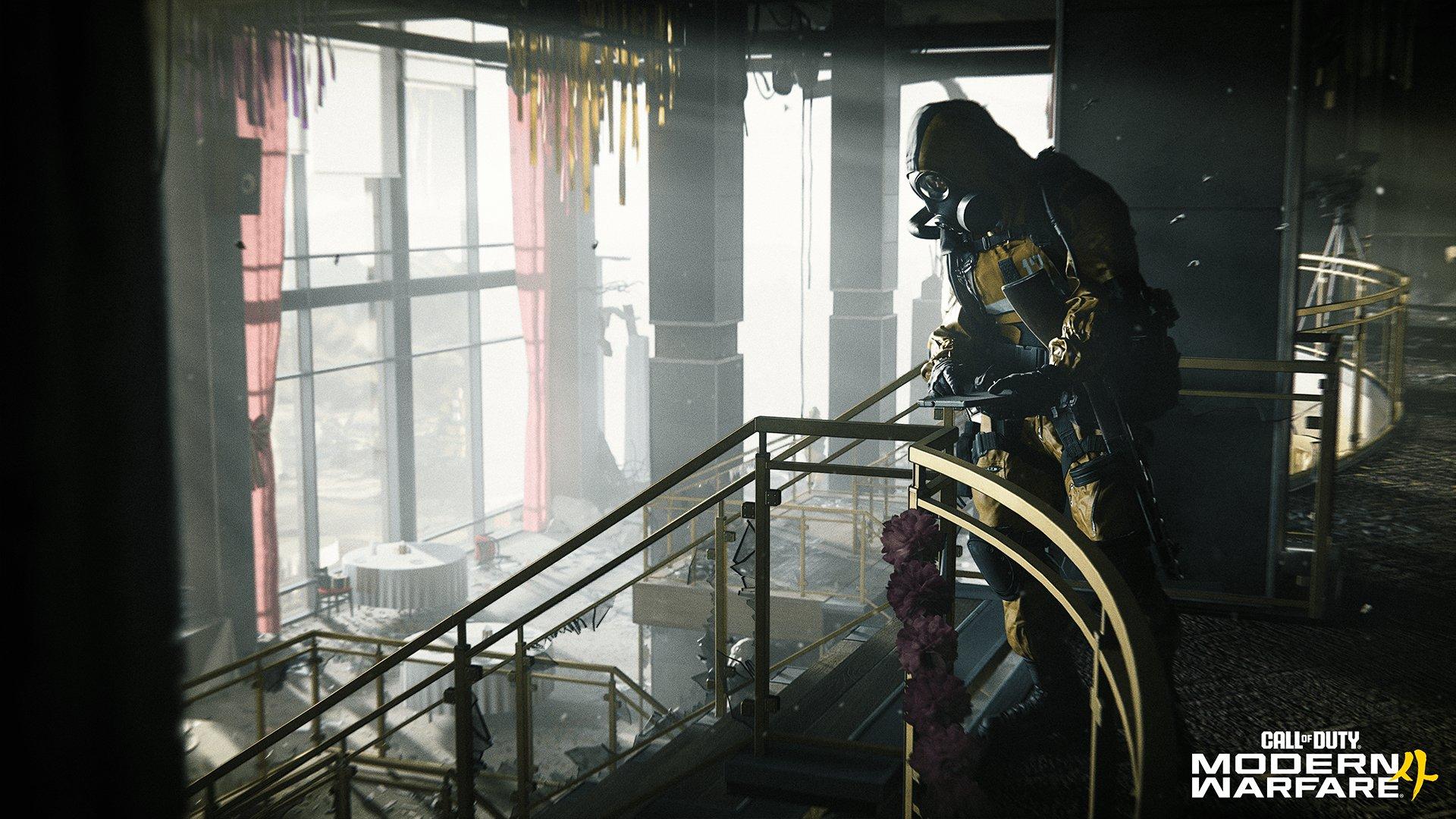 A soldier wearing a gas mask stands in an abandoned restaurant looking down from the first floor