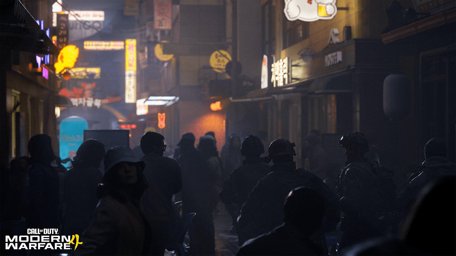 A group of people walk through a city at night