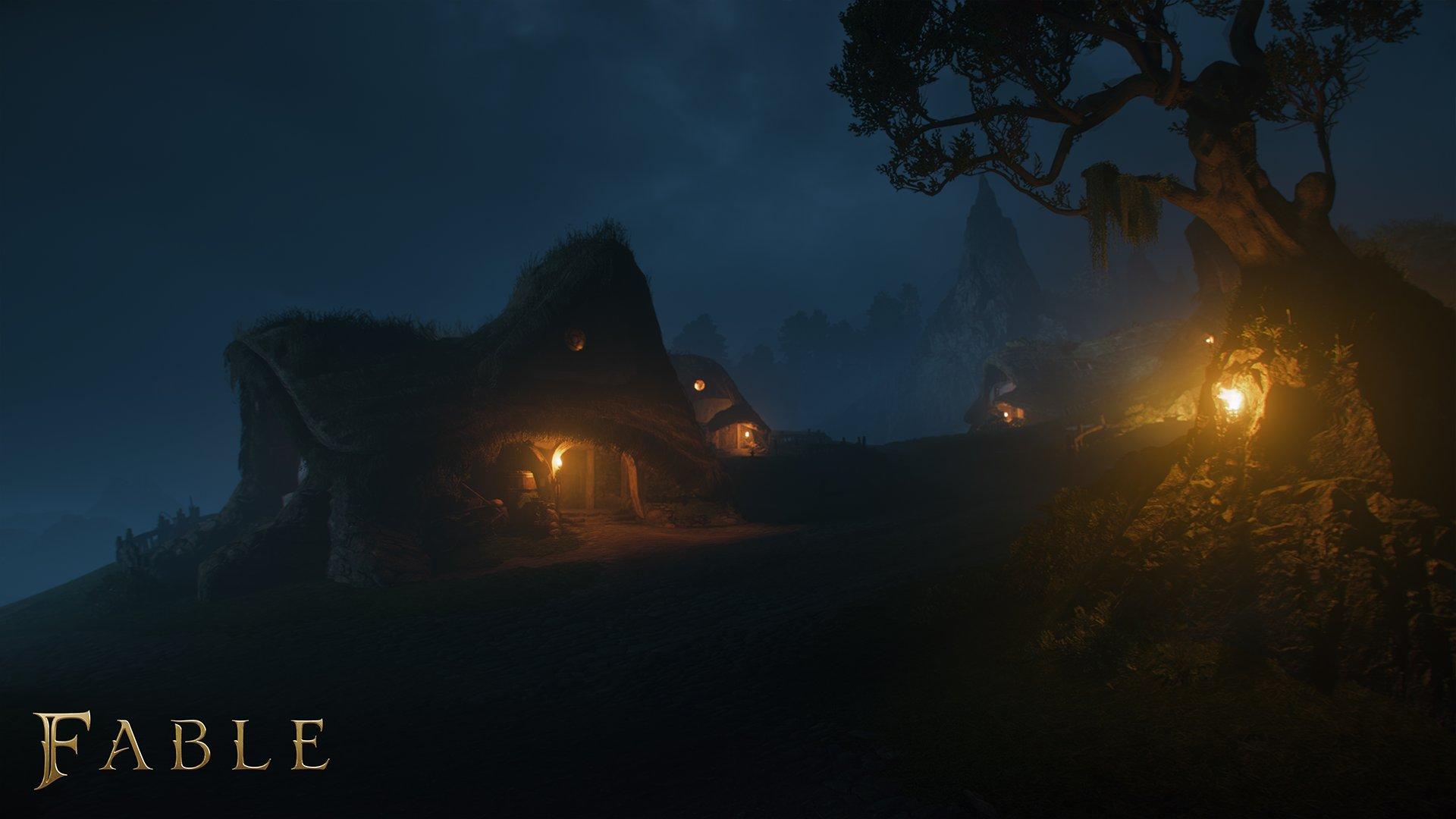 A group of buildings at night, lit by sconces