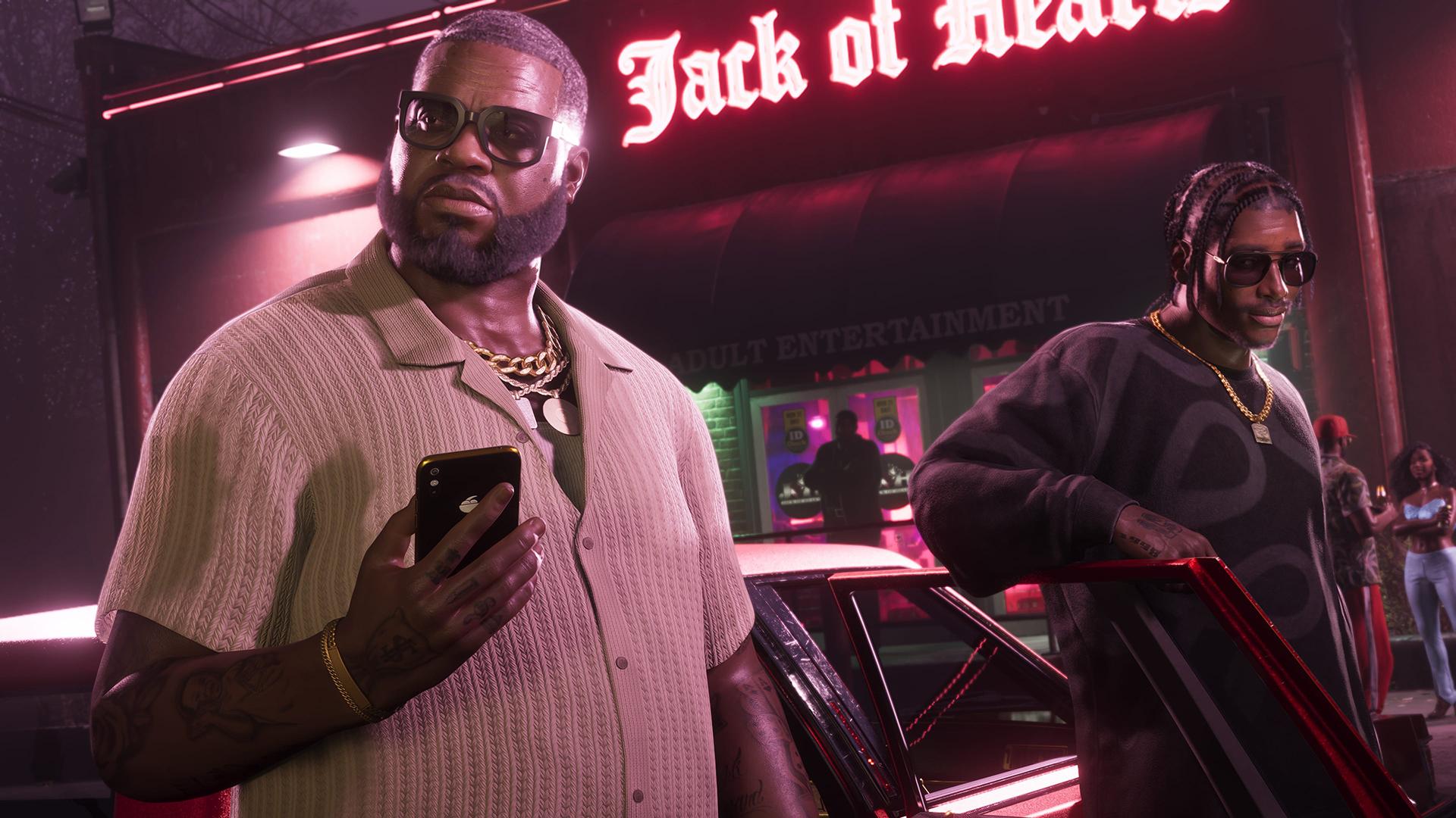Grand Theft Auto VI screenshot of two men standing next to a car, one holding a mobile phone