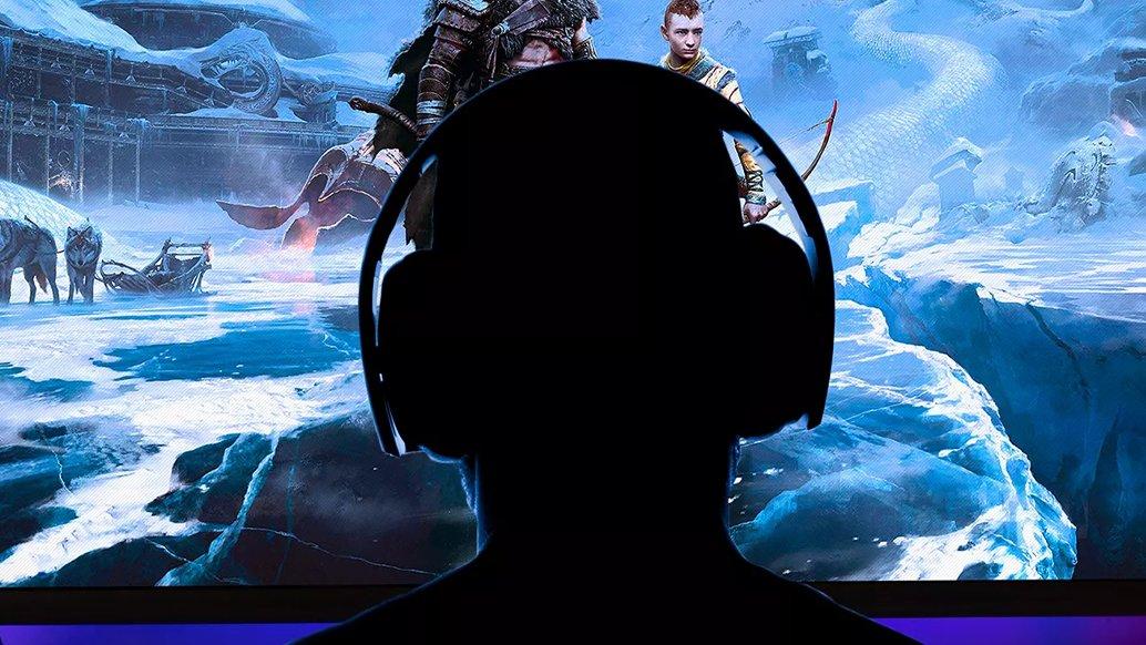 The silhouette of a head wearing a headset in front of a screen
