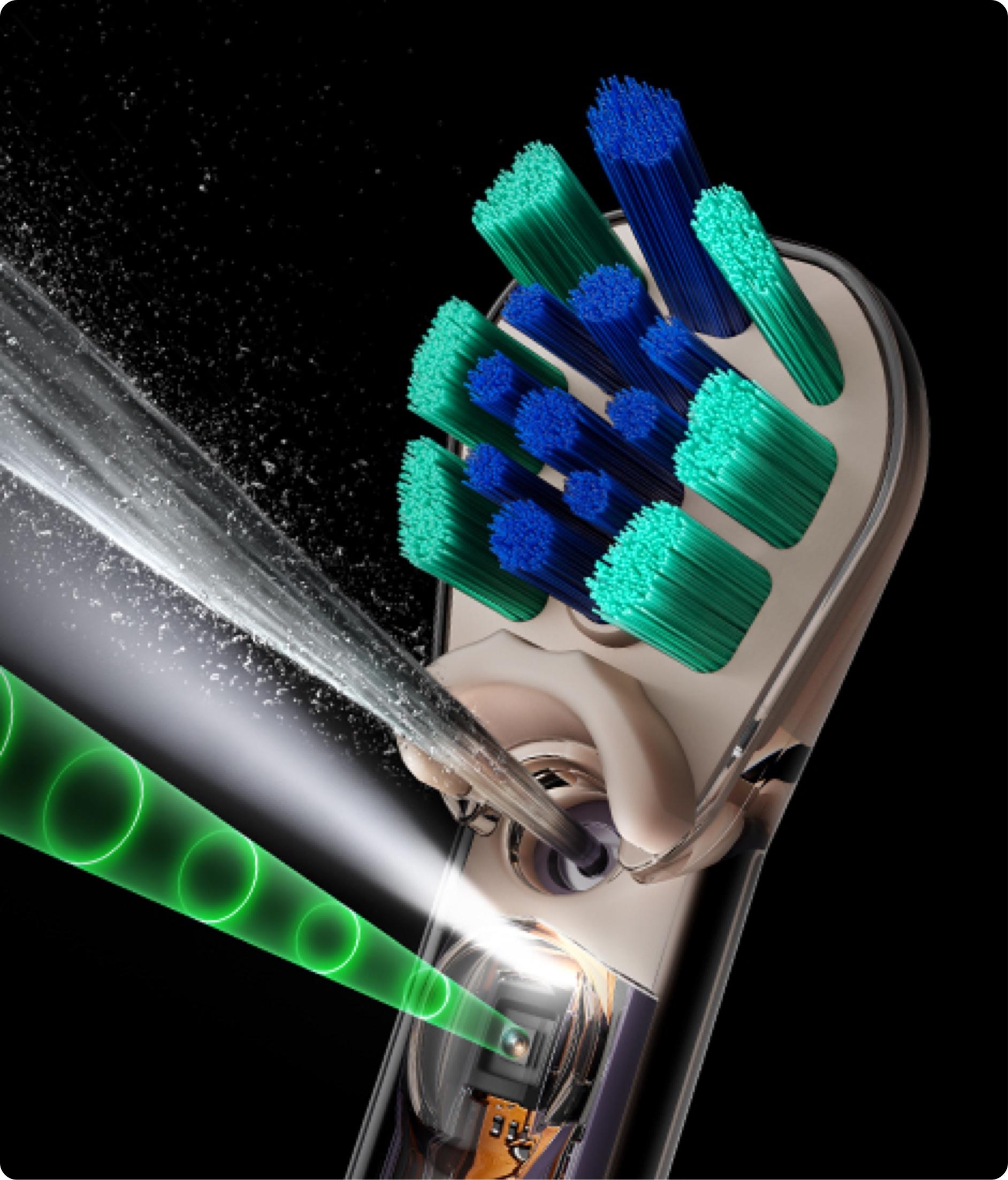 Close up of a toothbrush head with jets and a light indicating camera.