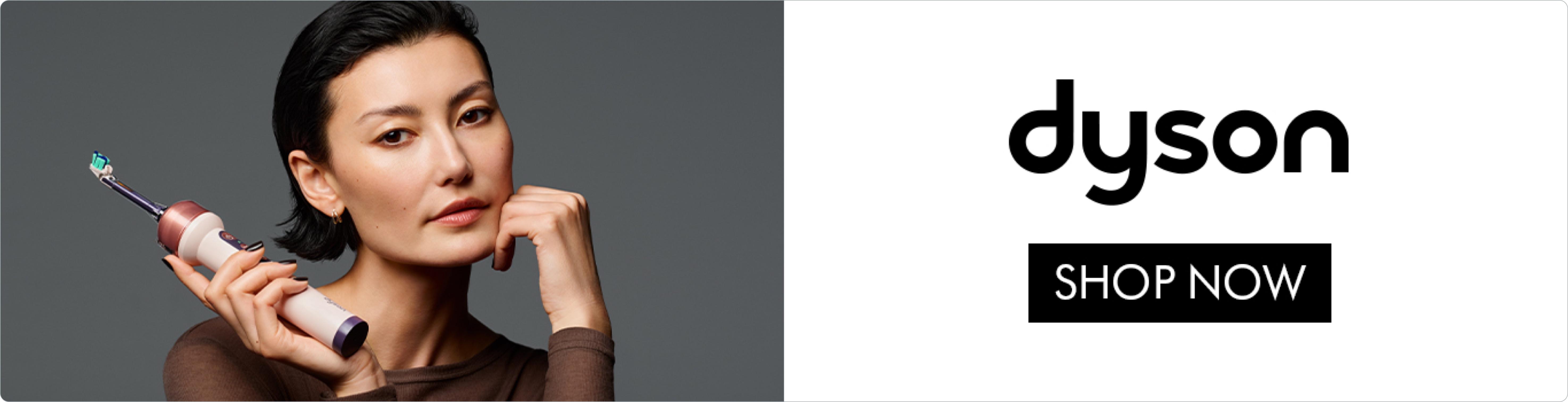 A woman holding the new Dyson toothbrush. Shop now.