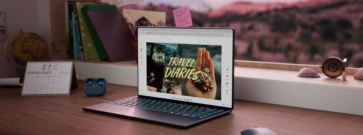 A Lenovo laptop on a desk in front of a window