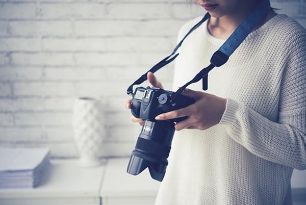 woman using DSLR camera