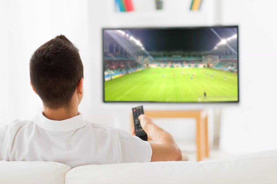 A man watching football on TV