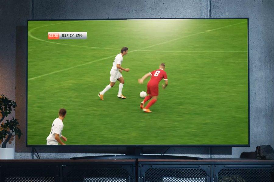 A large TV with a football match playing on it