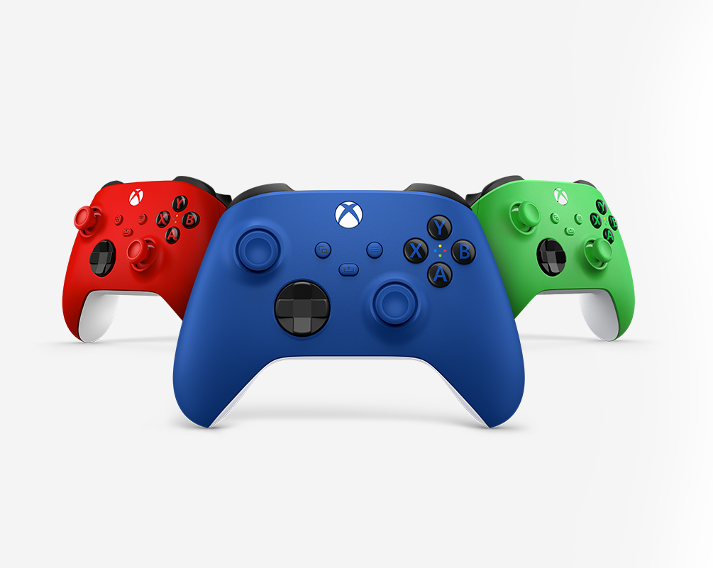 A blue Xbox controller with red and green controllers flanking it